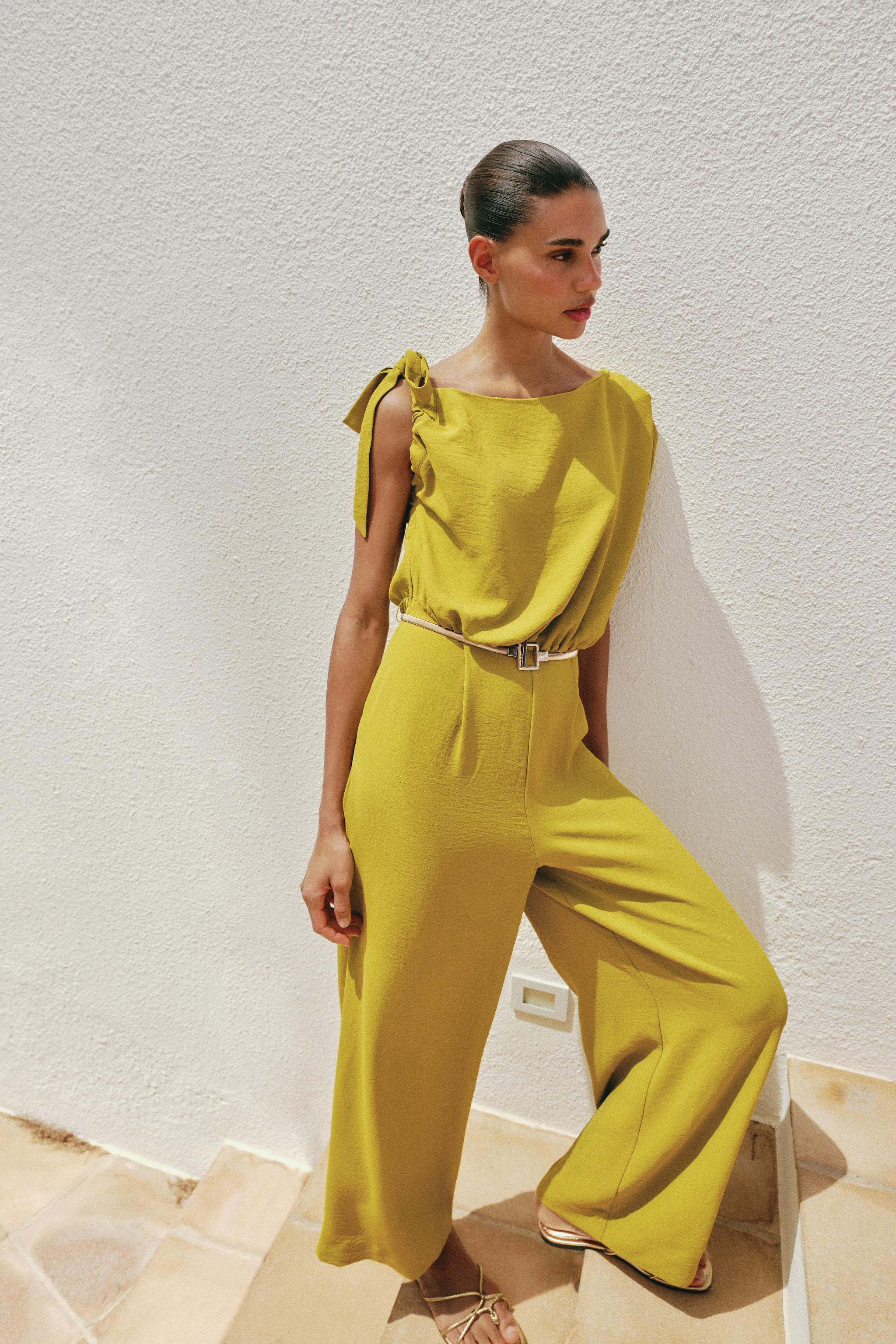 ASYMMETRIC SLEEVE BELTED JUMPSUIT